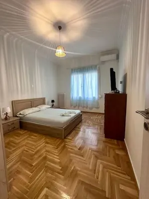 a bedroom with a bed and a television in it at Jorges house in athens in Athens