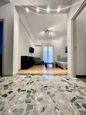 a large living room with a couch and a table at Jorges house in athens in Athens