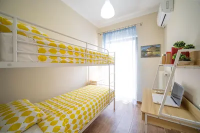 a bedroom with a yellow and white bunk bed at ΜΚ Αpartment 2ΥΔ - Nikea Metro in Piraeus