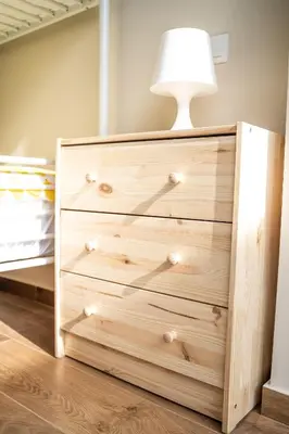 a wooden dresser with a lamp on top of it at ΜΚ Αpartment 2ΥΔ - Nikea Metro in Piraeus