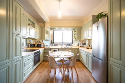 a kitchen with a table and chairs and a refrigerator at ΜΚ Αpartment 2ΥΔ - Nikea Metro in Piraeus