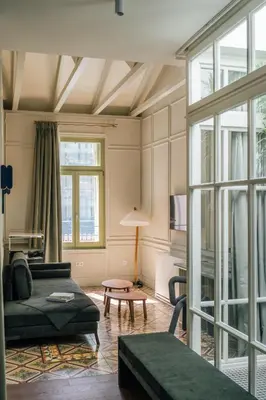 a living room with a couch and a table at Nosteo in Athens