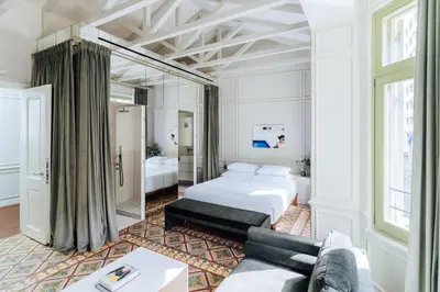 a hotel room with a bed and a couch at Nosteo in Athens