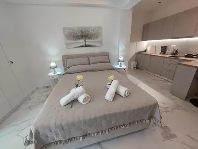 a bedroom with a large bed with towels on it at Maddie's Apartment in Athens
