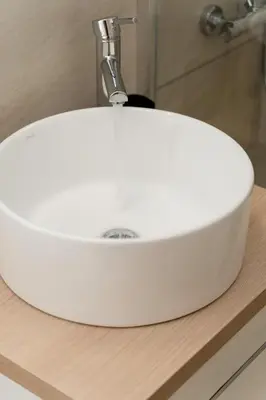 a white sink on a counter in a bathroom at Sandlight Apartment by A&D Properties in Porto Rafti