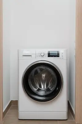 a white washer and dryer in a room at Sandlight Apartment by A&D Properties in Porto Rafti