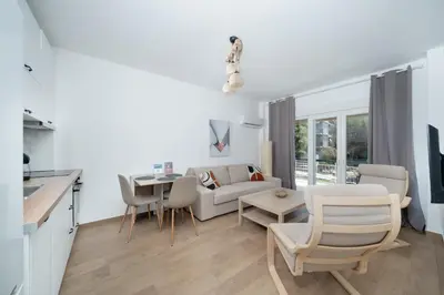 a living room with a couch and a table at Sandlight Apartment by A&D Properties in Porto Rafti