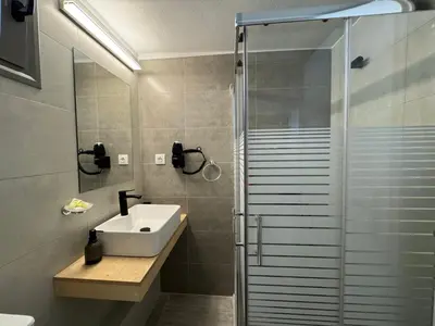 a bathroom with a sink and a shower at Tranquility 248 in Athens