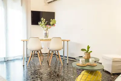 a living room with a table and two chairs at Urban Nights Athens in Athens