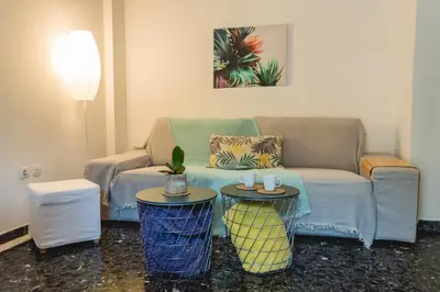 a living room with a couch and two tables at Urban Nights Athens in Athens
