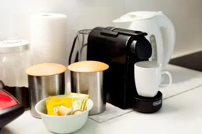 a coffee maker and cups on a counter at Urban Nights Athens in Athens