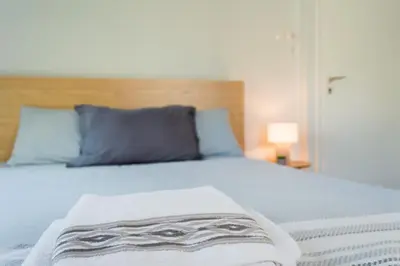 a bedroom with a bed with a blanket on it at Urban Nights Athens in Athens