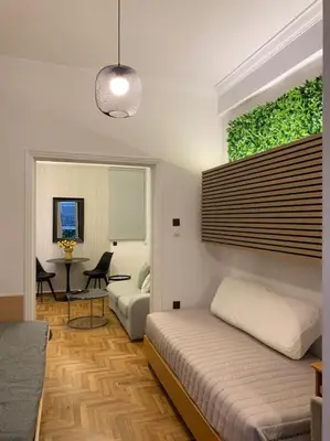a bedroom with a bed and a living room at Athens Flower Paradise near Acropoli in Athens