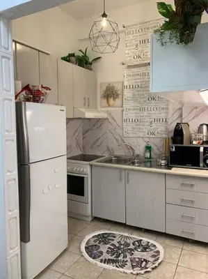 a kitchen with a white refrigerator and a sink at Athens Flower Paradise near Acropoli in Athens