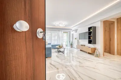 a living room with a door and a living room with a table at Athens Riviera, seaview, beachfront, Lux Apartment on Starbucks building in Athens