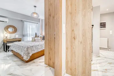 a bedroom with a bed and a wooden wall at Athens Riviera, seaview, beachfront, Lux Apartment on Starbucks building in Athens