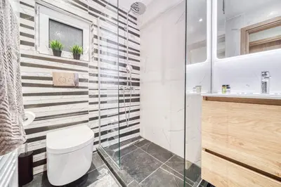 a bathroom with a toilet and a glass shower at Athens Riviera, seaview, beachfront, Lux Apartment on Starbucks building in Athens