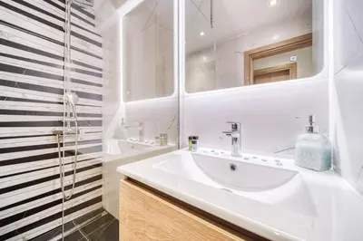 a white bathroom with a sink and a mirror at Athens Riviera, seaview, beachfront, Lux Apartment on Starbucks building in Athens