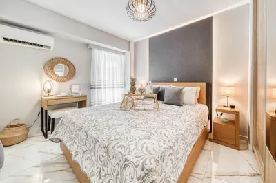 a bedroom with a large bed with a table on it at Athens Riviera, seaview, beachfront, Lux Apartment on Starbucks building in Athens