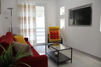 a living room with a red couch and a table at 