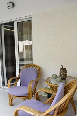 a porch with two chairs and a glass table at 
