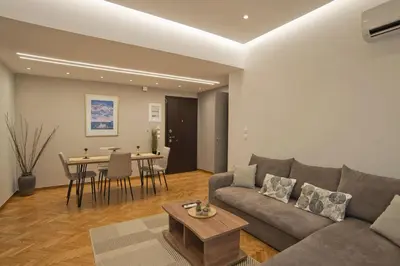 a living room with a couch and a table at Honey House Kipseli Stylish, Reno 2BR Apt City Ctr in Athens