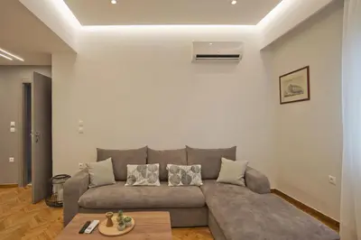 a living room with a couch and a table at Honey House Kipseli Stylish, Reno 2BR Apt City Ctr in Athens