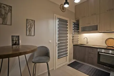 a kitchen with a table and a chair and a table at Honey House Kipseli Stylish, Reno 2BR Apt City Ctr in Athens