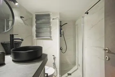 a bathroom with a black sink and a shower at Honey House Kipseli Stylish, Reno 2BR Apt City Ctr in Athens