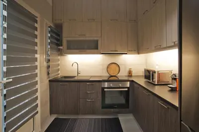 a kitchen with wooden cabinets and a sink at Honey House Kipseli Stylish, Reno 2BR Apt City Ctr in Athens