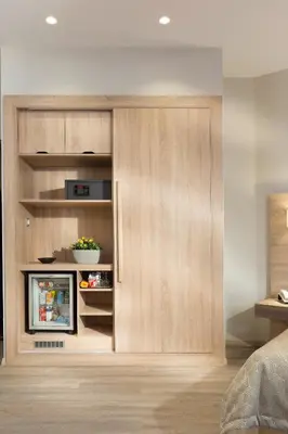 a bedroom with a wooden partition with a television in it at Jason Inn in Athens