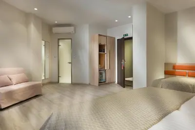 a living room with a bed and a couch at Jason Inn in Athens