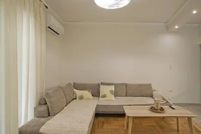 a living room with a couch and a table at Fabi's Place Luxurious 2BR, Fully Renovated Apt in Athens