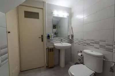 a white bathroom with a toilet and a sink at Private Entire Villa in Alimos in Athens