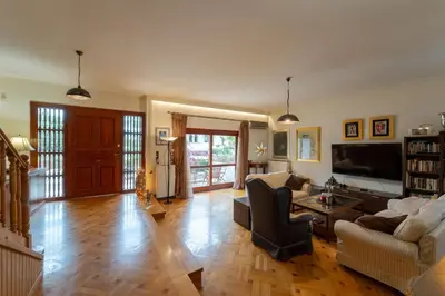 a living room with a couch and a tv at Private Entire Villa in Alimos in Athens