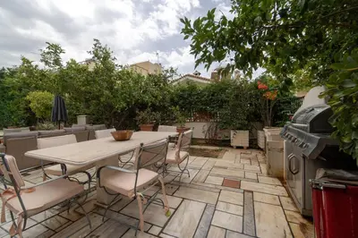 a patio with a table and chairs and a grill at Private Entire Villa in Alimos in Athens