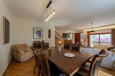 a dining room and living room with a table and chairs at Private Entire Villa in Alimos in Athens