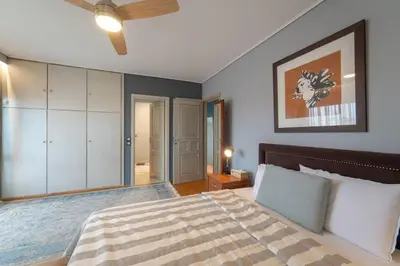 a bedroom with a bed and a ceiling fan at Private Entire Villa in Alimos in Athens