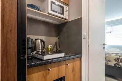 a kitchen with a sink and a microwave at Modern Studio in Syntagma - Walk to Acropolis in Athens