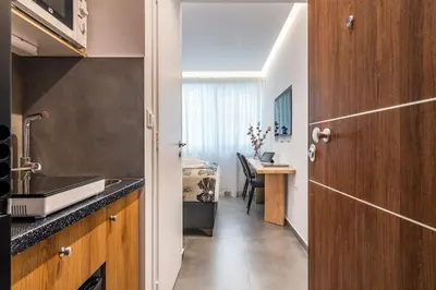 a kitchen with a sink and a table in a room at Modern Studio in Syntagma - Walk to Acropolis in Athens