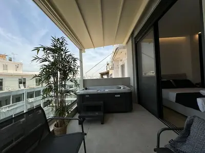 a room with a balcony with a bed and a desk at BlueMotion - CruiseNest 6Β in Piraeus