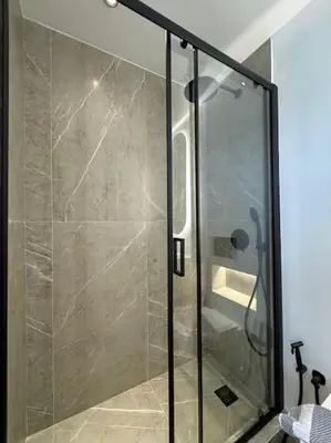a shower with a glass door in a bathroom at BlueMotion - CruiseNest 6Β in Piraeus