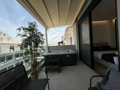a balcony with a tub and a bed on a building at BlueMotion - CruiseNest 6Β in Piraeus
