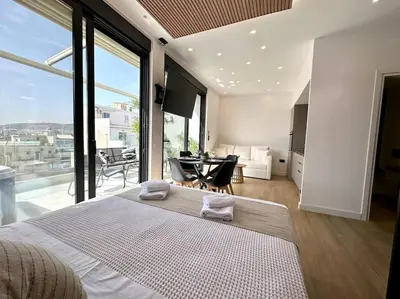 a bedroom with a large bed and a large window at BlueMotion - CruiseNest 6Α in Piraeus