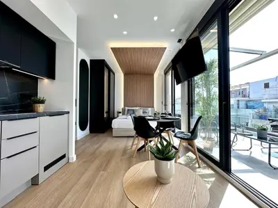 a kitchen and living room with a table and chairs at BlueMotion - CruiseNest 6Α in Piraeus