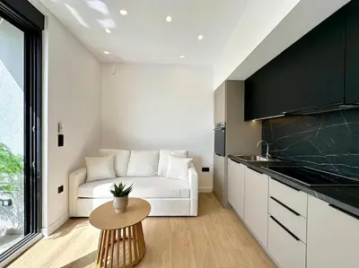 a living room with a white couch and a table at BlueMotion - CruiseNest 6Α in Piraeus