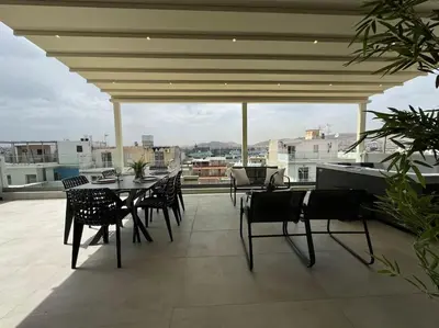 a balcony with a table and chairs and a piano at BlueMotion - CruiseNest PortView in Piraeus