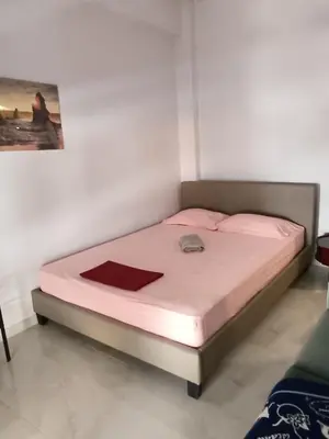 a bedroom with a bed with pink sheets and pink pillows at Classical beauty near Acropolis! in Athens