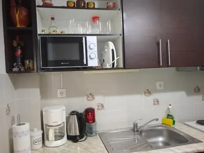 a kitchen counter with a sink and a microwave at Classical beauty near Acropolis! in Athens