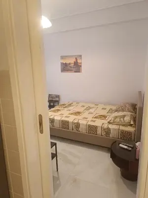 a bedroom with a bed and a table in a room at Classical beauty near Acropolis! in Athens